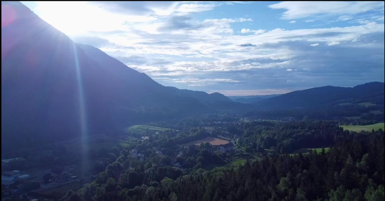 Scenic valley with sun flare over mountains